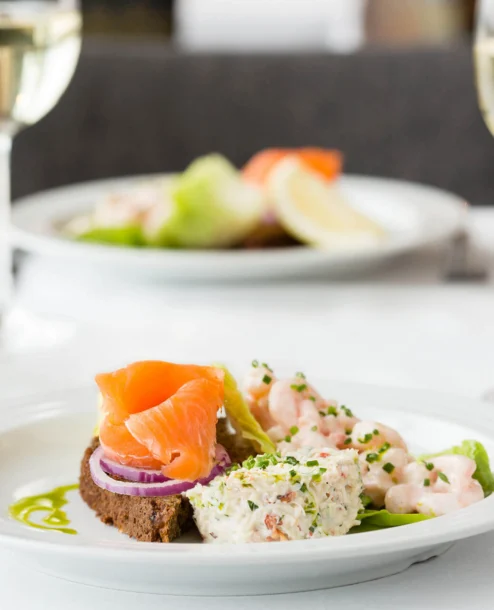 Elegant seafood starters with wine at The Galmont Hotel & Spa dining area.
