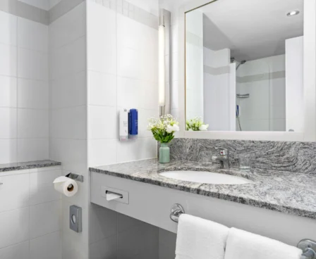 Modern bathroom with marble sink and fresh flowers at The Galmont Hotel & Spa.