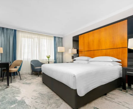 Modern hotel room with king-sized bed, seating area, and large window at The Galmont Hotel & Spa.