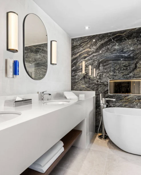 Luxurious marble bathroom with a freestanding tub at The Galmont Hotel.