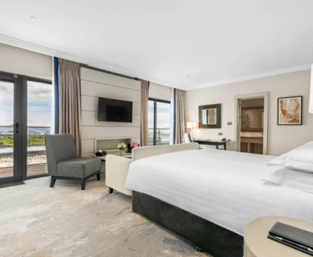 Elegant hotel room with a sea view and cosy seating area.