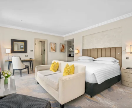 Spacious hotel room at The Galmont with king-size bed, stylish decor, and modern amenities.