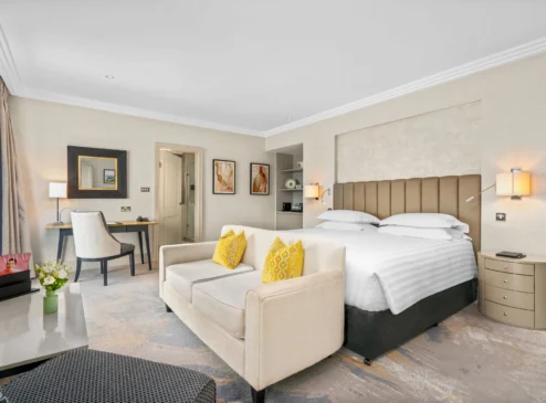 Spacious hotel room at The Galmont with king-size bed, stylish decor, and modern amenities.
