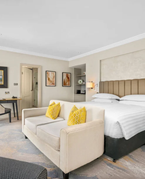 Spacious hotel room at The Galmont with king-size bed, stylish decor, and modern amenities.
