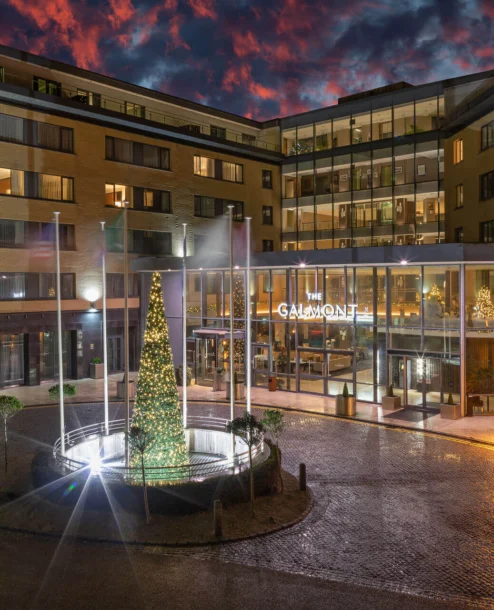 Family enjoying a festive evening outside The Galmont Hotel & Spa entrance.