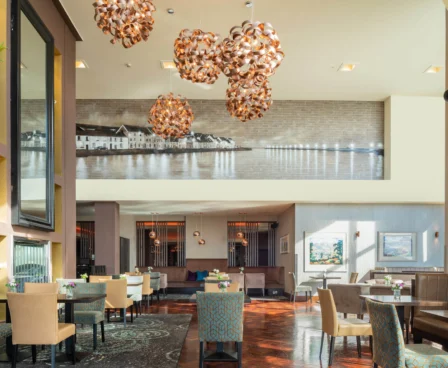 Stylish hotel lobby dining area with modern decor and family enjoying a meal.