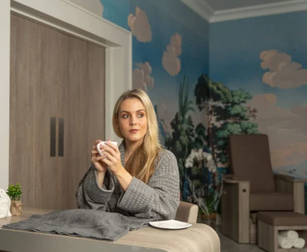 Relaxed woman enjoying tea in a serene spa room at The Galmont Hotel.