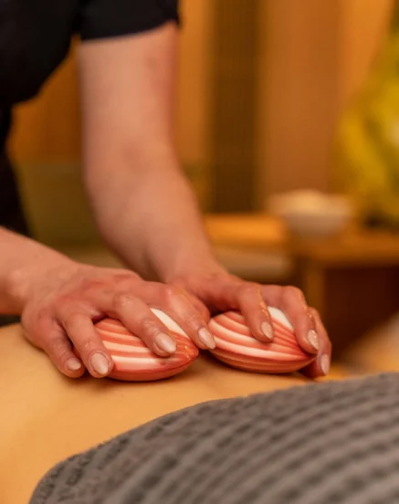Relaxing spa massage at The Galmont Hotel & Spa, featuring warm shell stones.