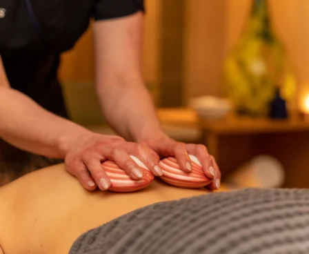 Relaxing spa massage at The Galmont Hotel & Spa, featuring warm shell stones.
