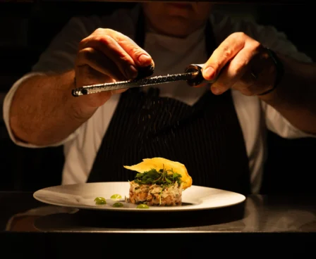 Chef garnishing a gourmet dish at The Galmont Hotel’s restaurant.