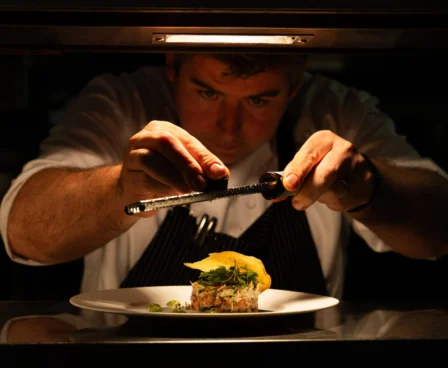 Chef artfully preparing a gourmet dish at The Galmont Hotel.