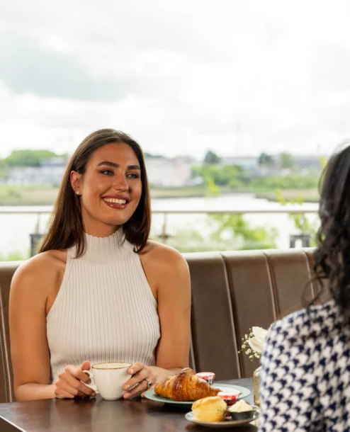 Family enjoying breakfast with a river view at The Galmont Hotel & Spa.