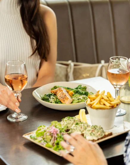 Couples enjoying gourmet dining with drinks at The Galmont Hotel.