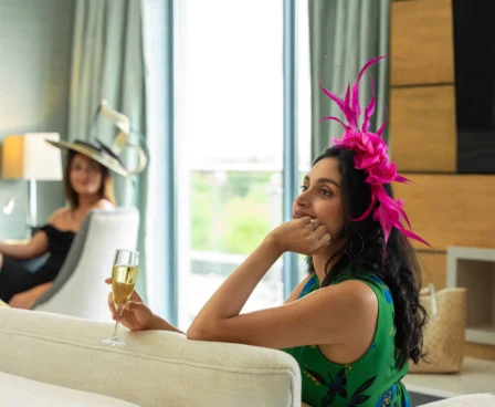 A couple relaxing in a stylish hotel room with champagne.