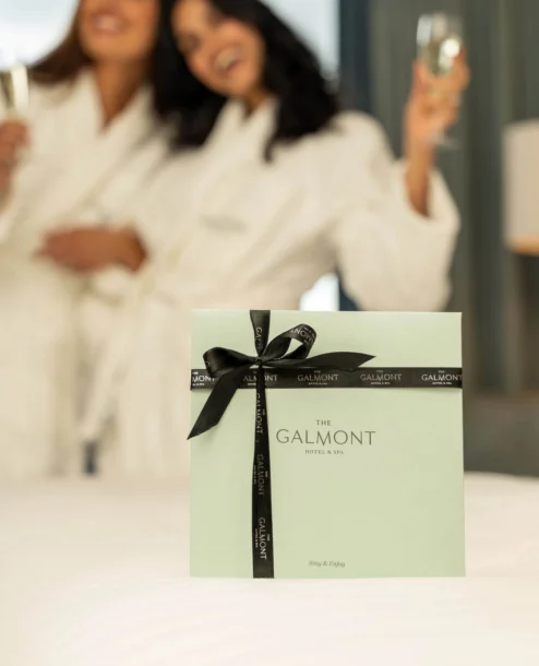 Two people in robes enjoying champagne at The Galmont Hotel & Spa.