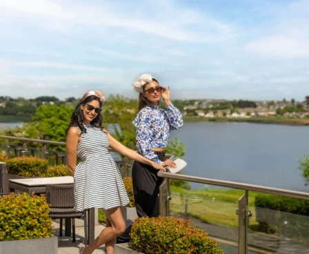 Two women enjoying a sunny day on The Galmont Hotel terrace overlooking the lake.