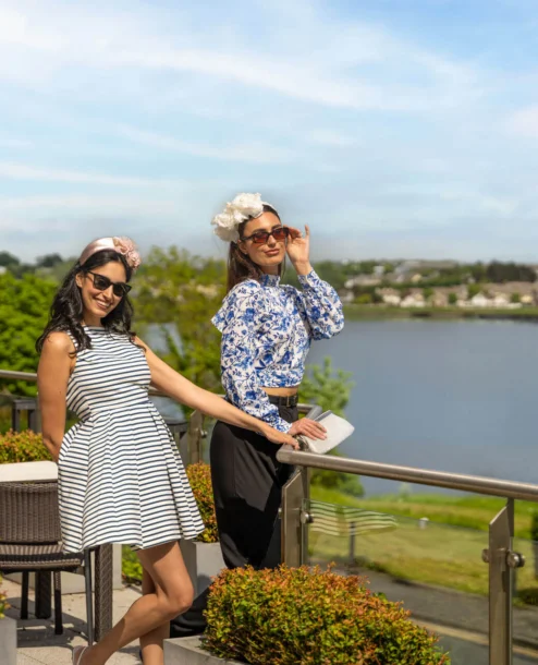 Two women enjoying a sunny day on The Galmont Hotel terrace overlooking the lake.