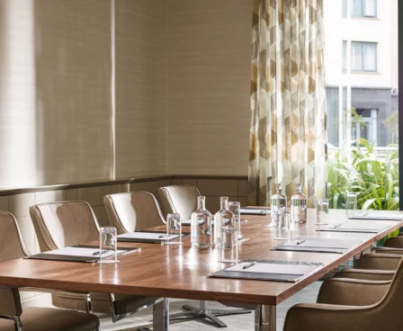 Modern meeting room with natural light and elegant furnishings at The Galmont Hotel.