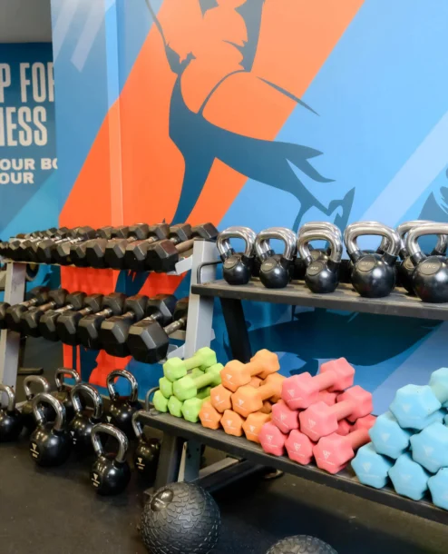 Modern gym with colourful weights and motivational wall art at The Galmont Hotel & Spa.
