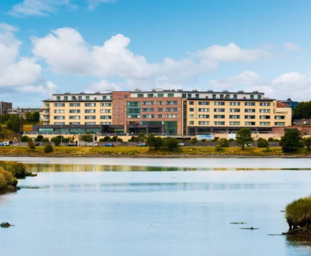 Family enjoying a stay at The Galmont Hotel & Spa beside a tranquil lake on a sunny day.