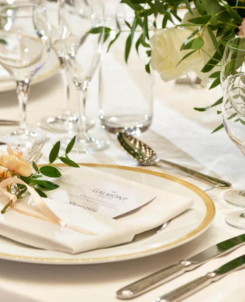 Elegant table setting at The Galmont Hotel with floral decor and sparkling glassware.