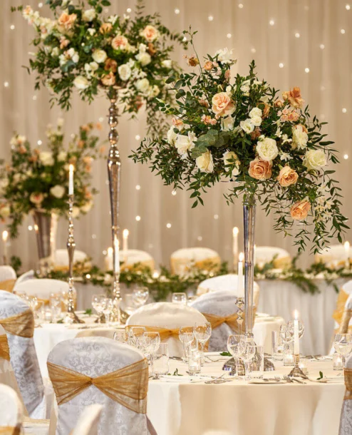 Elegant wedding reception with floral centrepieces and candlelit ambiance.