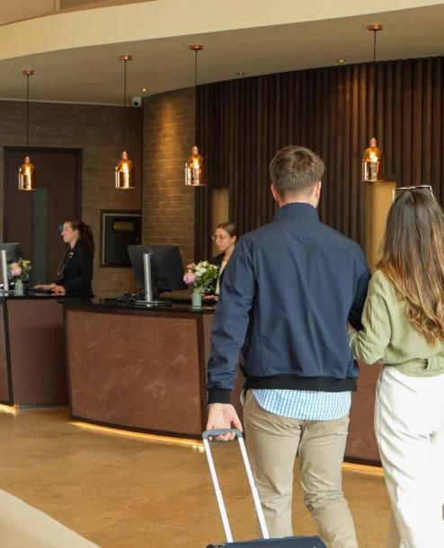 A couple checks in at The Galmont Hotel's welcoming reception desk.