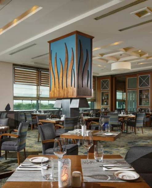 Elegant restaurant at The Galmont Hotel & Spa with stylish seating and large windows.