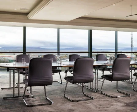 Conference room with panoramic view at The Galmont Hotel & Spa. TABLEs, chairs, and large windows.