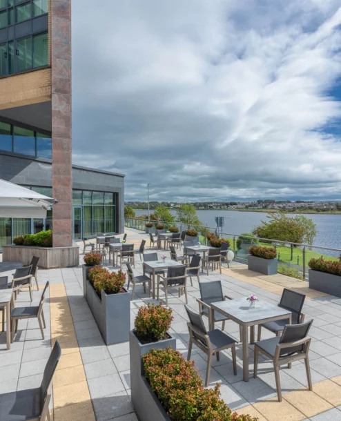 Family enjoying sunny terrace with lake view at The Galmont Hotel