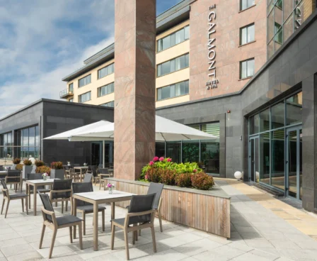 A serene outdoor dining area at The Galmont Hotel & Spa, with patio tables under a canopy, ideal for families or couples to relax.