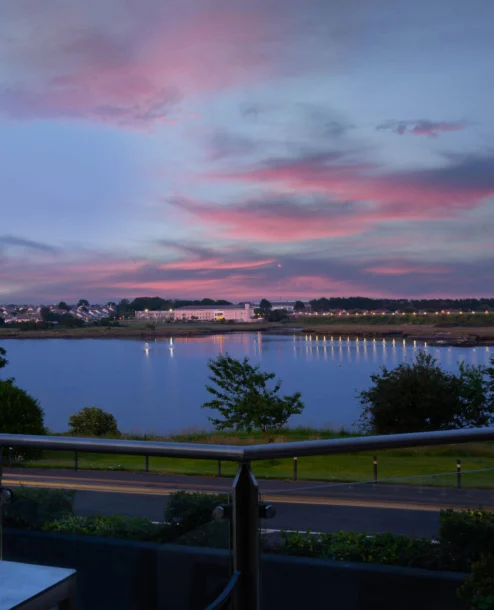 Family enjoying a sunset view over the bay from The Galmont Hotel & Spa terrace.