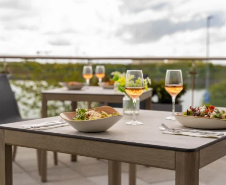 Outdoor dining setup overlooking a serene lake at The Galmont Hotel.