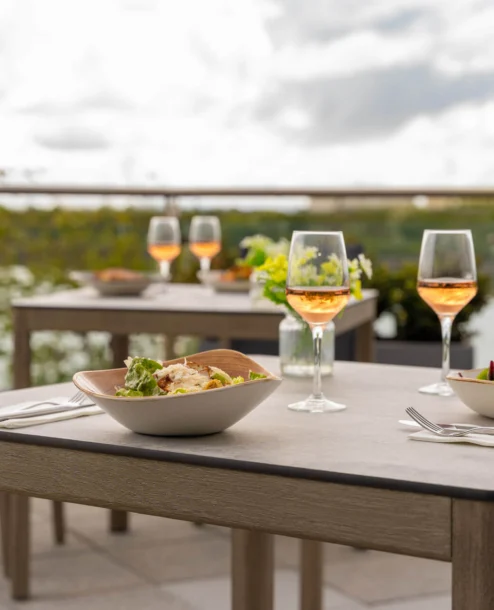 Outdoor dining setup overlooking a serene lake at The Galmont Hotel.