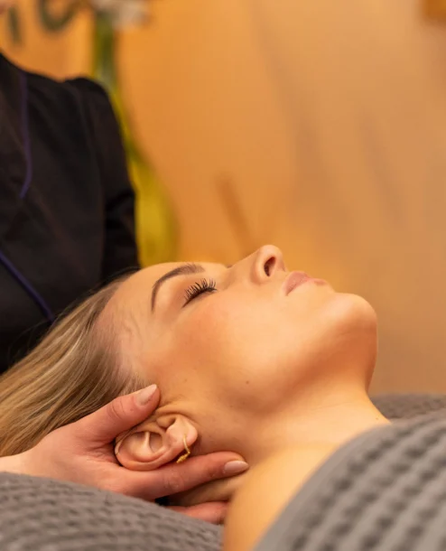 A serene woman enjoys a soothing spa treatment at Galmont Hotel's luxurious spa.