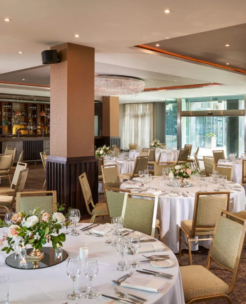 Elegant dining area in The Galmont Hotel, set for a family gathering with round tables.