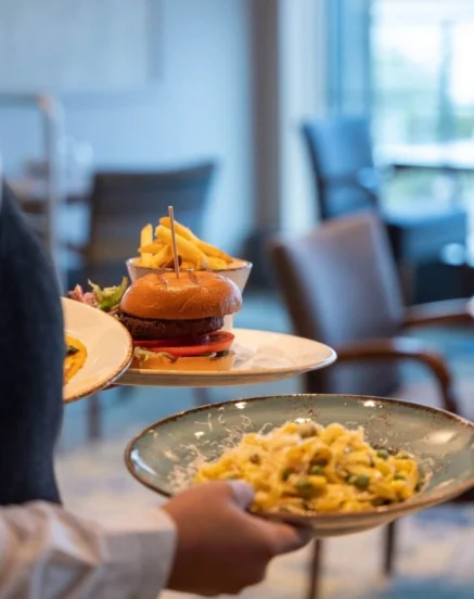 Server delivering gourmet meals to a restaurant table at The Galmont Hotel & Spa.
