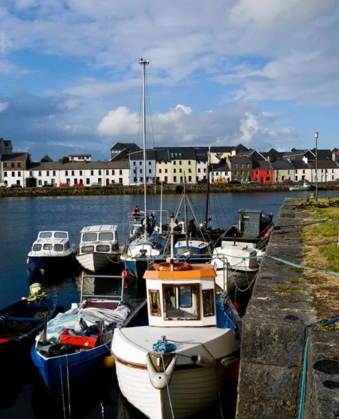 Scenic harbour view near The Galmont Hotel with colourful buildings and moored boats.