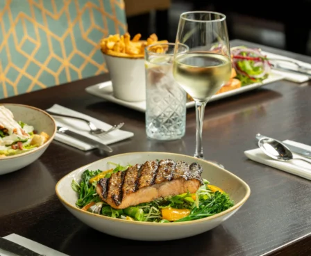 Elegant dining setup with salmon dish and wine at The Galmont Hotel & Spa.