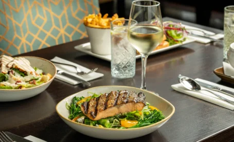 Elegant dining setup with salmon dish and wine at The Galmont Hotel & Spa.