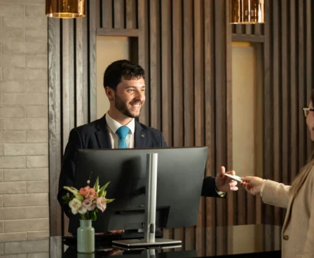 A warm welcome at The Galmont's reception desk with smiling staff member.