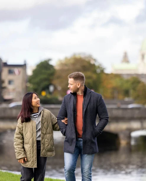 Young couple strolling by a scenic riverside near The Galmont Hotel & Spa.