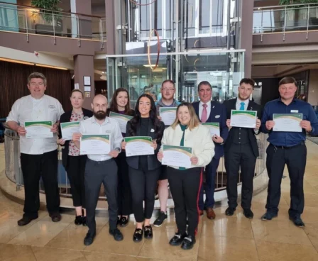 Team members proudly displaying certificates in The Galmont Hotel & Spa lobby.