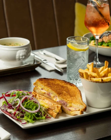 Elegant dining with gourmet sandwiches, salads, and drinks at The Galmont Hotel.