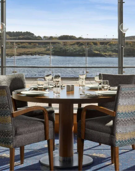 Elegant dining setup with sea view at The Galmont Hotel & Spa, inviting coastal scenery.