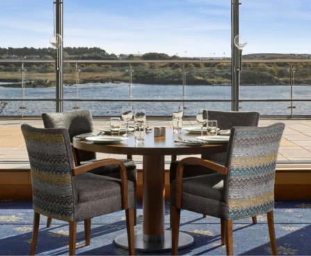 Elegant dining setup with sea view at The Galmont Hotel & Spa, inviting coastal scenery.