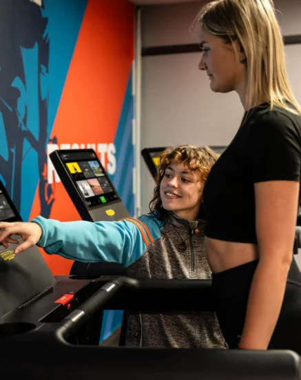 A happy couple use modern treadmills at The Galmont Hotel & Spa gym.